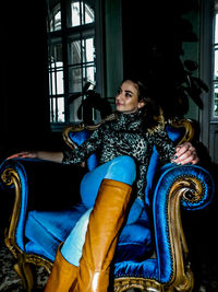 Portrait of young woman sitting at home