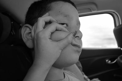 Portrait of cute boy in car