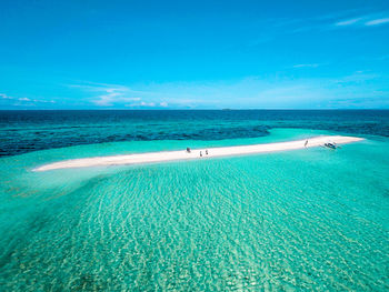 Scenic view of beach against blue sky