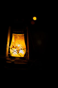 Low angle view of illuminated lamp at night
