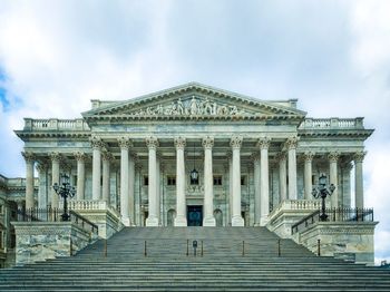 Low angle view of building against cloudy sky