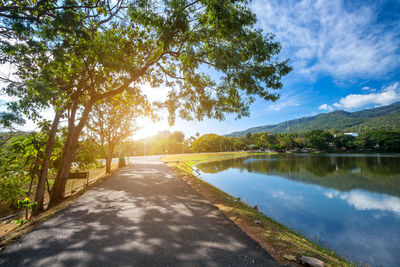 Scenic view of lake by trees against sky