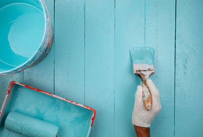 Close-up of clothes hanging on blue wall