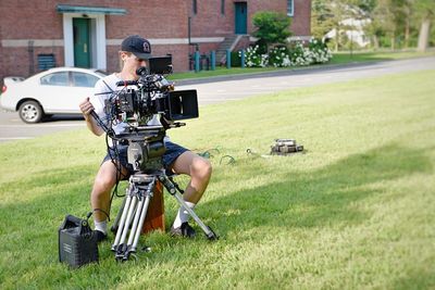 Man photographing with camera on grass