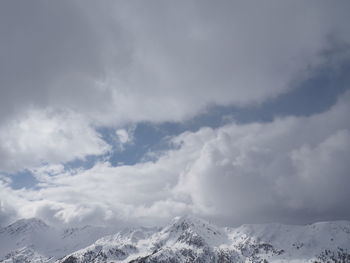 Scenic view of snow covered mountains against sky