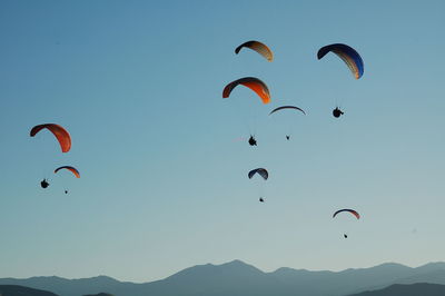 Low angle view of paragliders