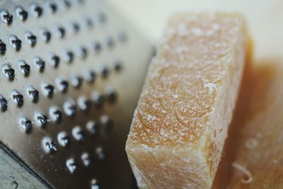 Close-up of cheese by grater