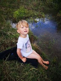 Portrait of cute girl sitting on grassy field