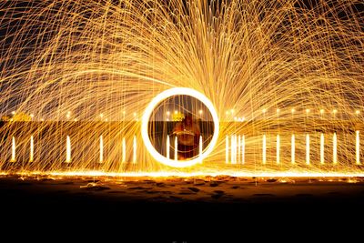 Light trails at night with steelwool with a lake view background 