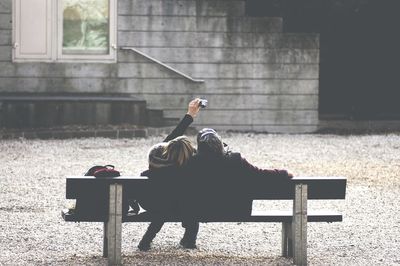 Full length of woman standing on bench