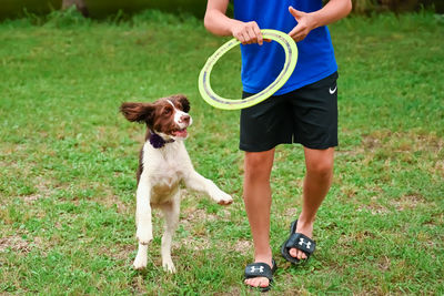 Side view of dog running on field