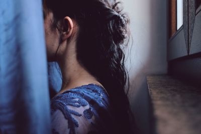 Close-up portrait of young woman at home