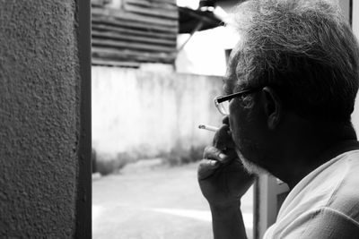 Portrait of man smoking cigarette outdoors