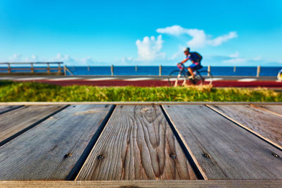 Man on pier over sea against sky