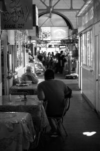 Rear view of man walking in corridor