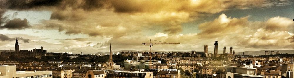 Cityscape against cloudy sky