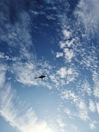 Low angle view of silhouette airplane flying in sky