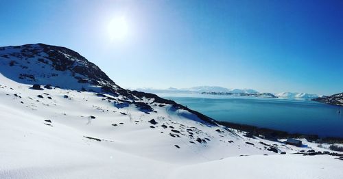 Scenic view of snowcapped mountains against clear blue sky