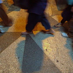 Low section of people walking on road