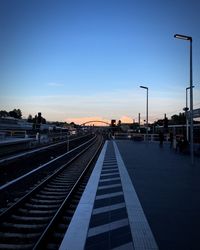 View of railroad station platform at sunset