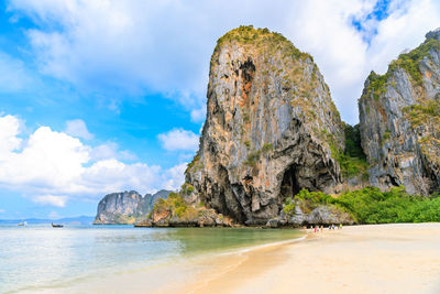 Rock formation on beach against sky