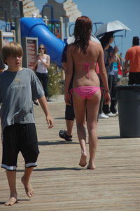 Rear view of women walking on floor