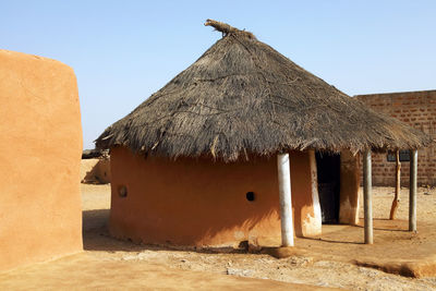 Mud huts in village at rajasthan against clear sky