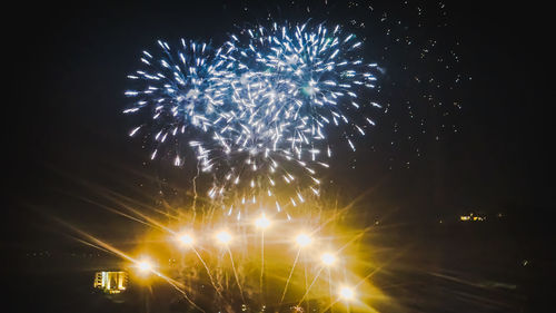 Low angle view of firework display at night