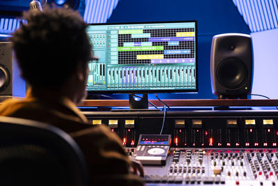 Rear view of woman using sound mixer