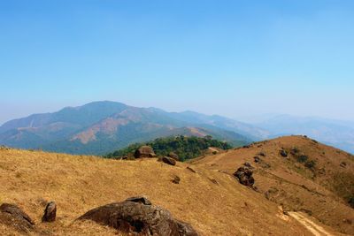 Scenic view of mountains against clear blue sky