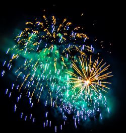 Low angle view of firework display at night