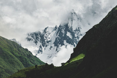 Scenic view of snowcapped mountains against sky