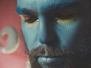 Close-up of serious man with painted face