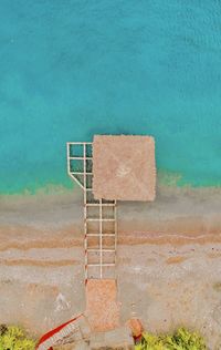 High angle view of ladder by swimming pool