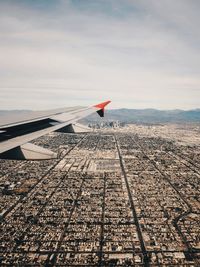 Airplane wing against sky