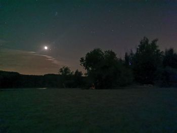 Scenic view of field against sky at night