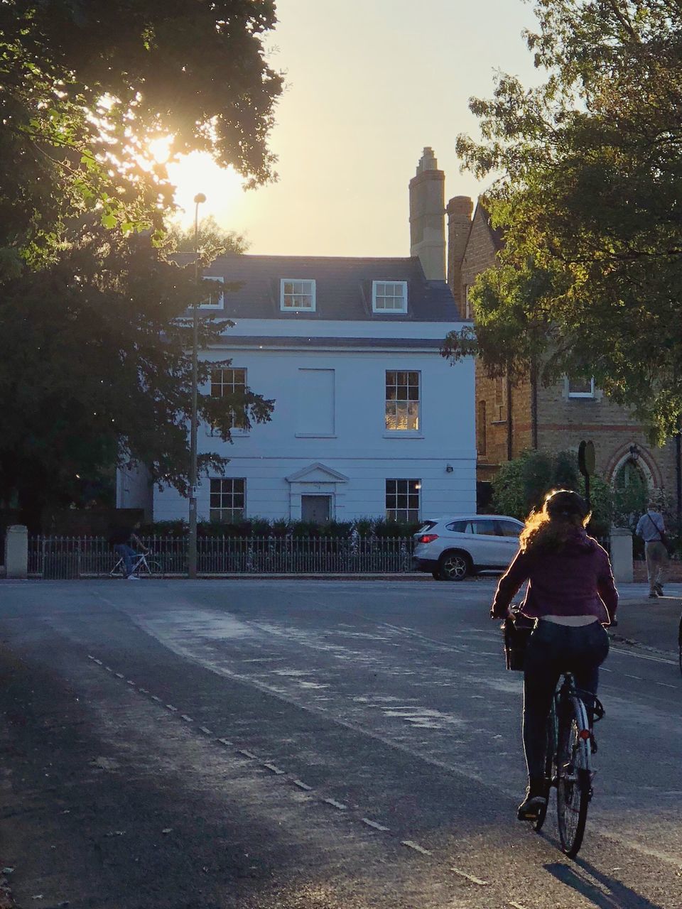 FULL LENGTH REAR VIEW OF MAN RIDING BICYCLE ON STREET