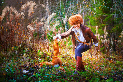 Side view of girl playing in forest