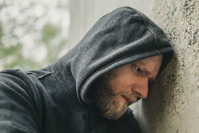 Man leaning on wall