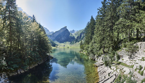 Scenic view of lake and mountains against sky