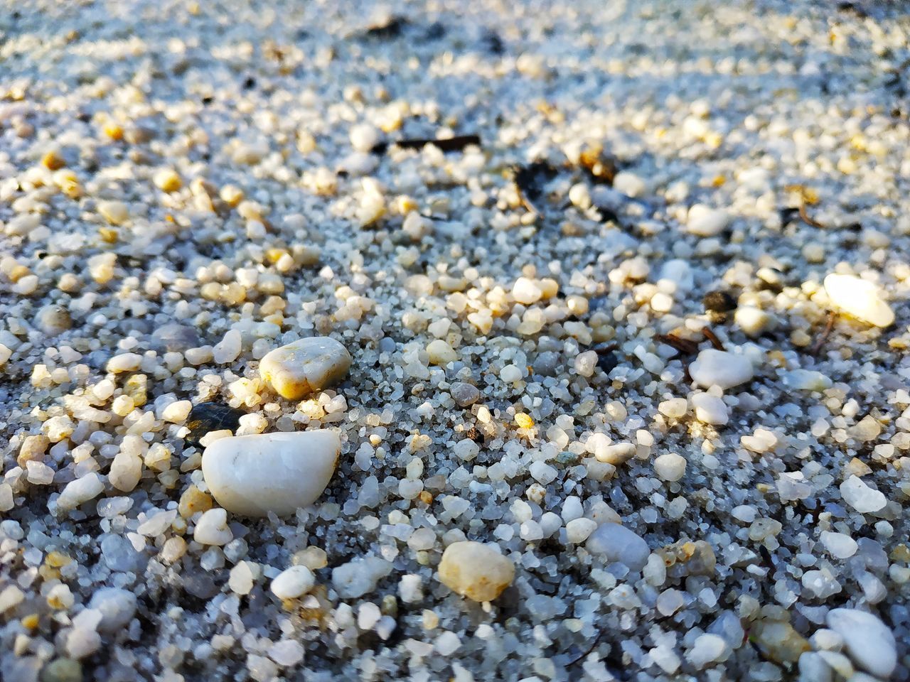 CLOSE-UP OF STONES ON SAND