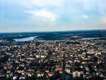 High angle view of townscape by sea against sky