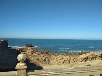 Scenic view of sea against clear blue sky