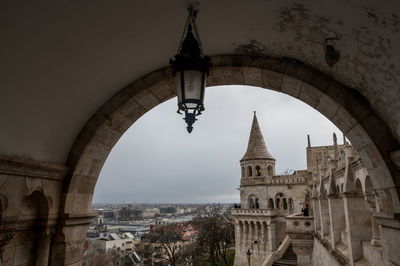 Arch bridge and buildings against sky