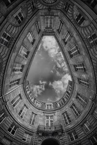 Low angle view of building against cloudy sky