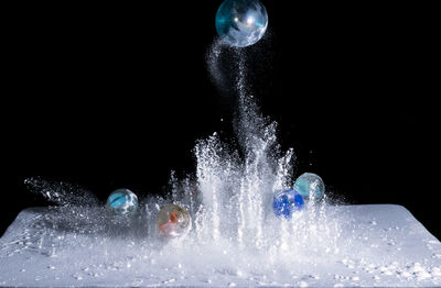 Close-up of water splashing against black background