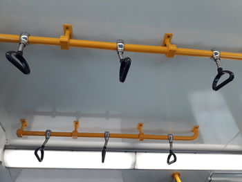 Low angle view of handles hanging at bus