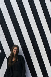 Portrait of young woman standing outdoors
