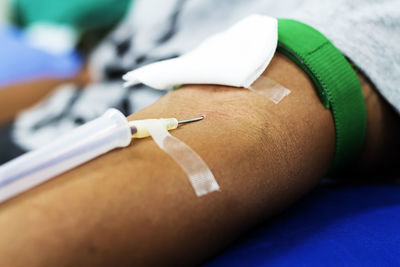 Close-up of human hand with iv drip