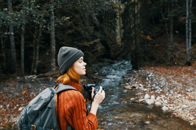 Man looking away in forest